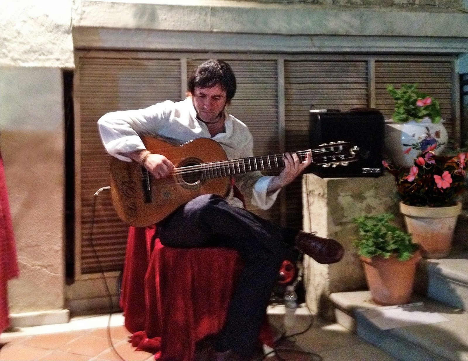 Kike tocando flamenco con guitarra española en un patio